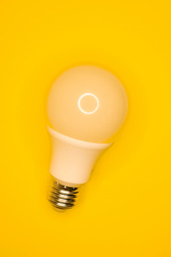Lampadina bianca su fondo giallo, simbolo del consumo elettrico